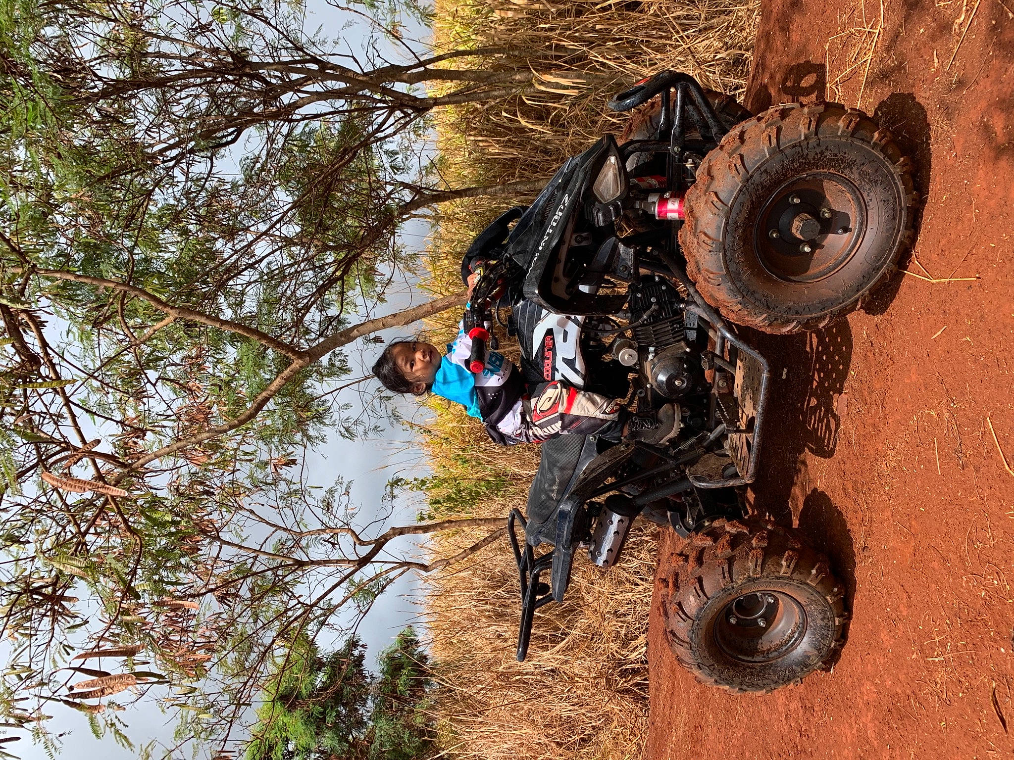 Ky is registered to the contest to win money with this photo: all_terrain_vehicle, auto_part, automotive_design, automotive_exterior, automotive_tire, automotive_wheel_system, car, fender, motor_vehicle, off_road_racing, person, plant, recreation, rim, rolling, synthetic_rubber, tire, tread, tree, vehicle