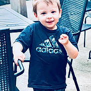 Oakley joined the competition — help win amazing prizes! child, boy, smiling, outdoor, patio, chair, table, clothing, tshirt, camo, shorts, happy, person, furniture, playful, young, casual, daylight, portrait, motion