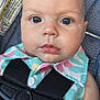 Stella is registered to the contest to win money with this photo: baby, child, car_seat, harness, face, eyes, clothing, infant, closeup, safety, warning_label, seat_belt, cute, portrait, skin, hand, expression, fabric, head, person