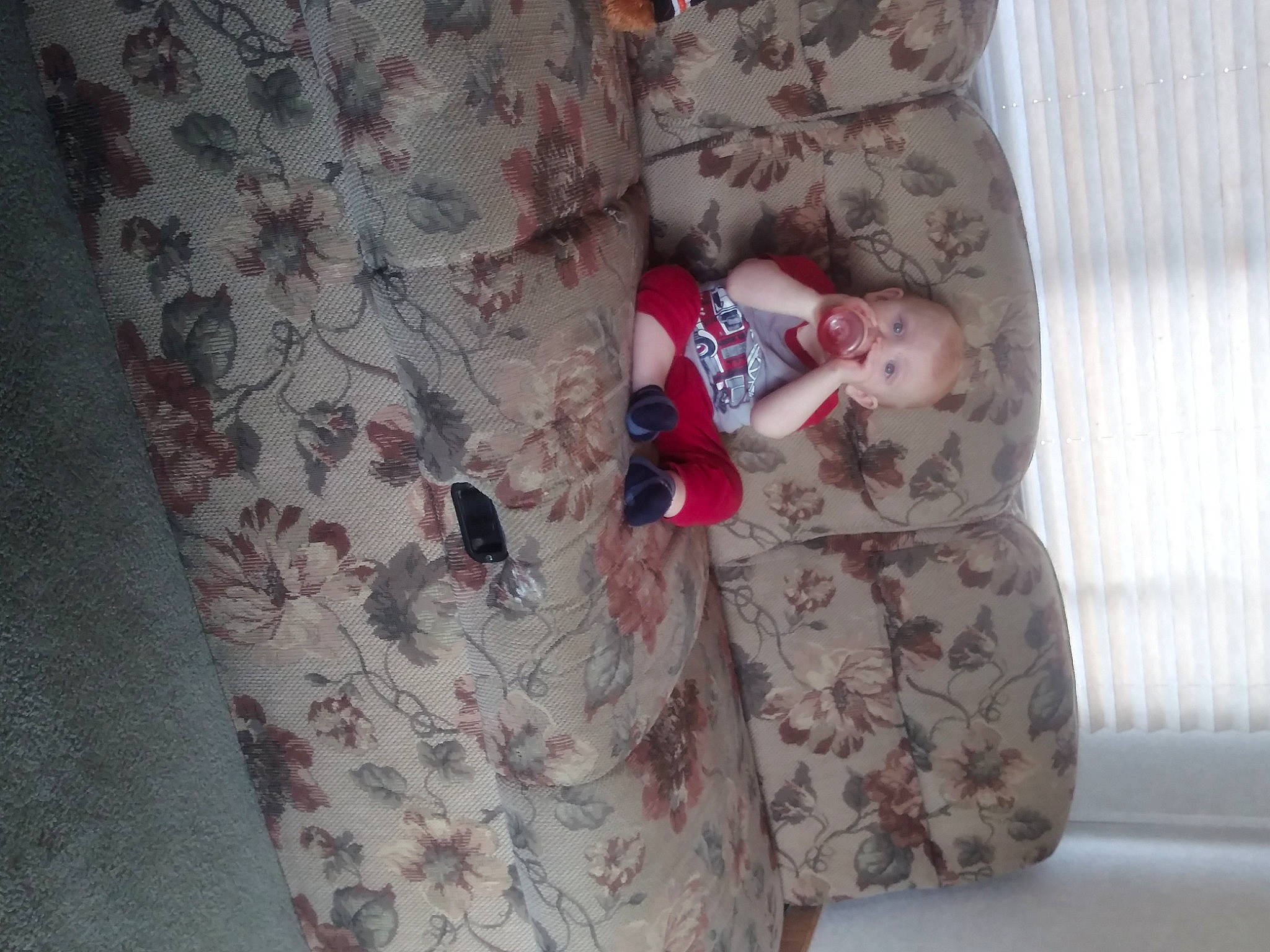 Rowan is registered to the contest to win money with this photo: arm, baby_toddler_clothing, comfort, day_dress, dress, flooring, grey, hand, human_body, human_leg, leg, linens, pattern, person, pink, sleeve, suit, t_shirt, textile, thigh