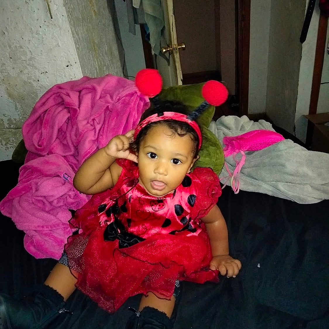 Jenesiah is registered to the contest to win money with this photo: baby, bed, bedroom, cap, clothing, coat, costume, cushion, dress, face, furniture, hat, head, homedecor, indoors, pants, person, photography, portrait, room