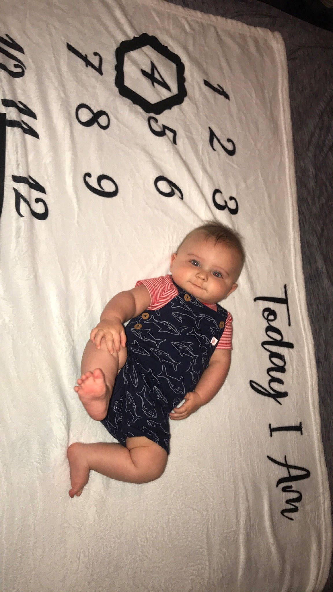 Xavier joined the competition — help win amazing prizes! baby, baby_toddler_clothing, child, comfort, face, finger, flash_photography, font, gesture, happy, linens, pattern, person, skin, sleeve, stomach, t_shirt, textile, thigh, thumb