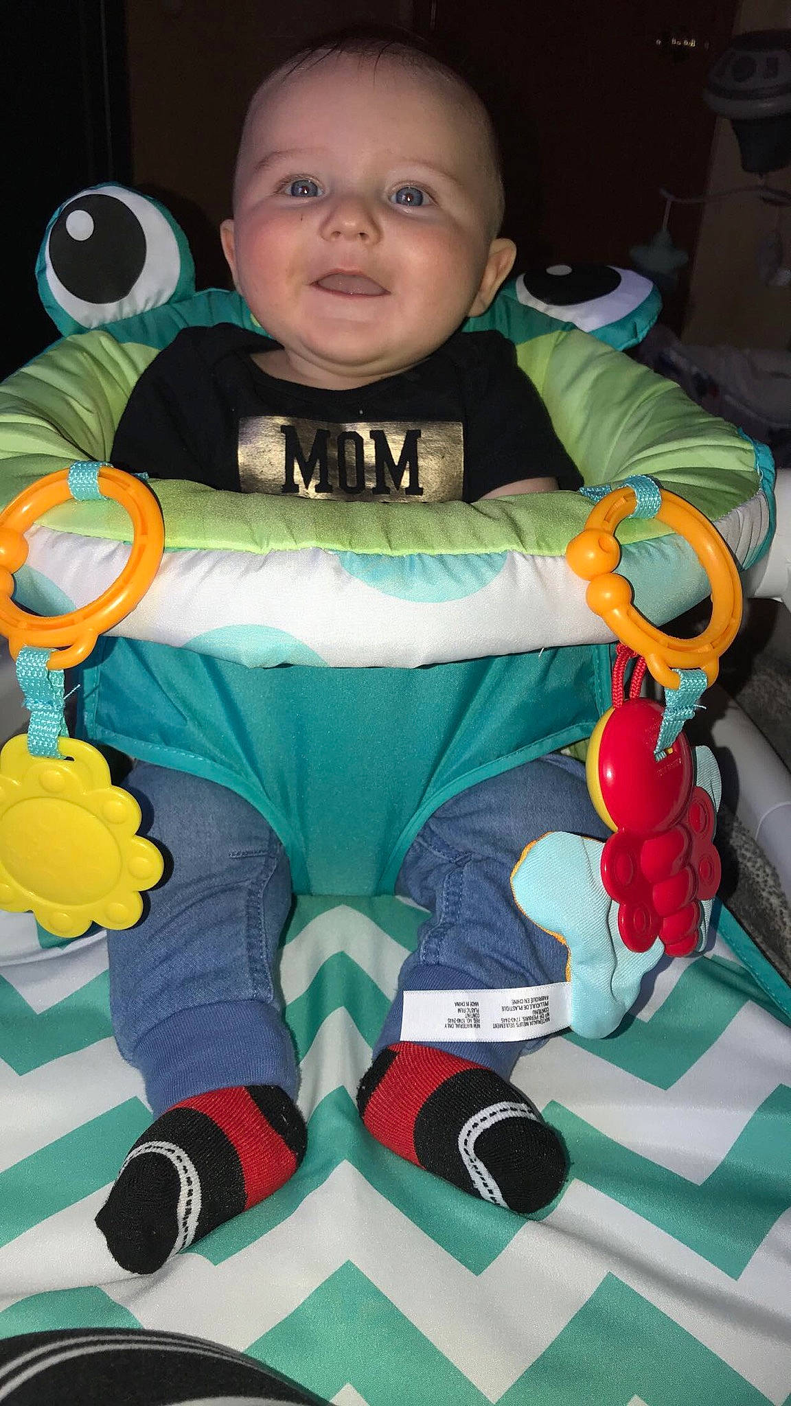 Xavier joined the competition — help win amazing prizes! baby, baby_products, baby_toddler_clothing, child, comfort, fictional_character, fun, glove, green, lap, linens, person, personal_protective_equipment, recreation, sitting, smile, snapshot, sock, textile, toddler