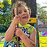 Rhettlee joined the competition — help win amazing prizes! child, boy, rope, swing, tree, outdoor, sunlight, dinosaur_shirt, curly_hair, temporary_tattoos, playful, tongue_out, backyard, grass, inflatable_pool, summer, fun, happy, nature, daytime