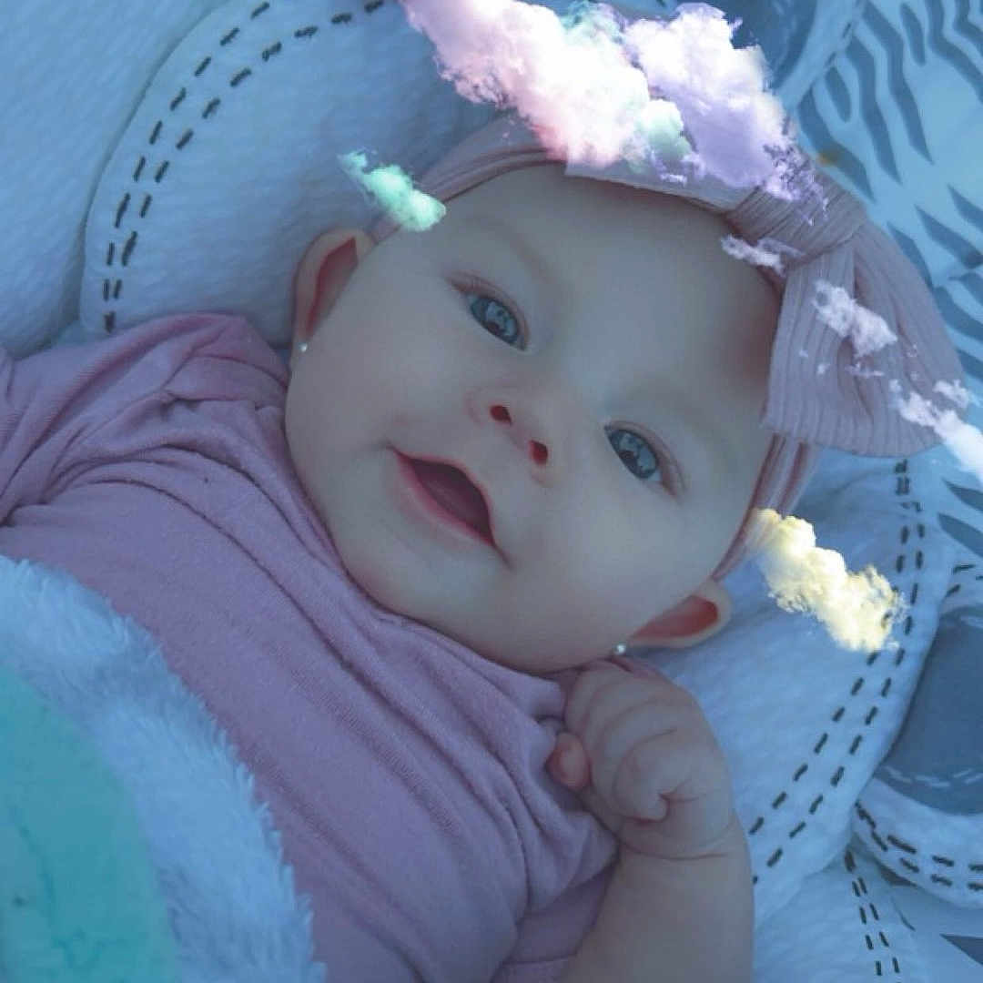 River joined the competition — help win amazing prizes! baby, blanket, bonnet, cap, clothing, coat, costume, face, flower, furniture, happy, hat, head, newborn, person, petal, photography, plant, portrait, smile