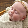 Lottie is registered to the contest to win money with this photo: baby, sleeping, blanket, headband, knitted, cushion, soft, peaceful, infant, face, skin, resting, closeup, portrait, child, newborn, cozy, warm, indoor, cute