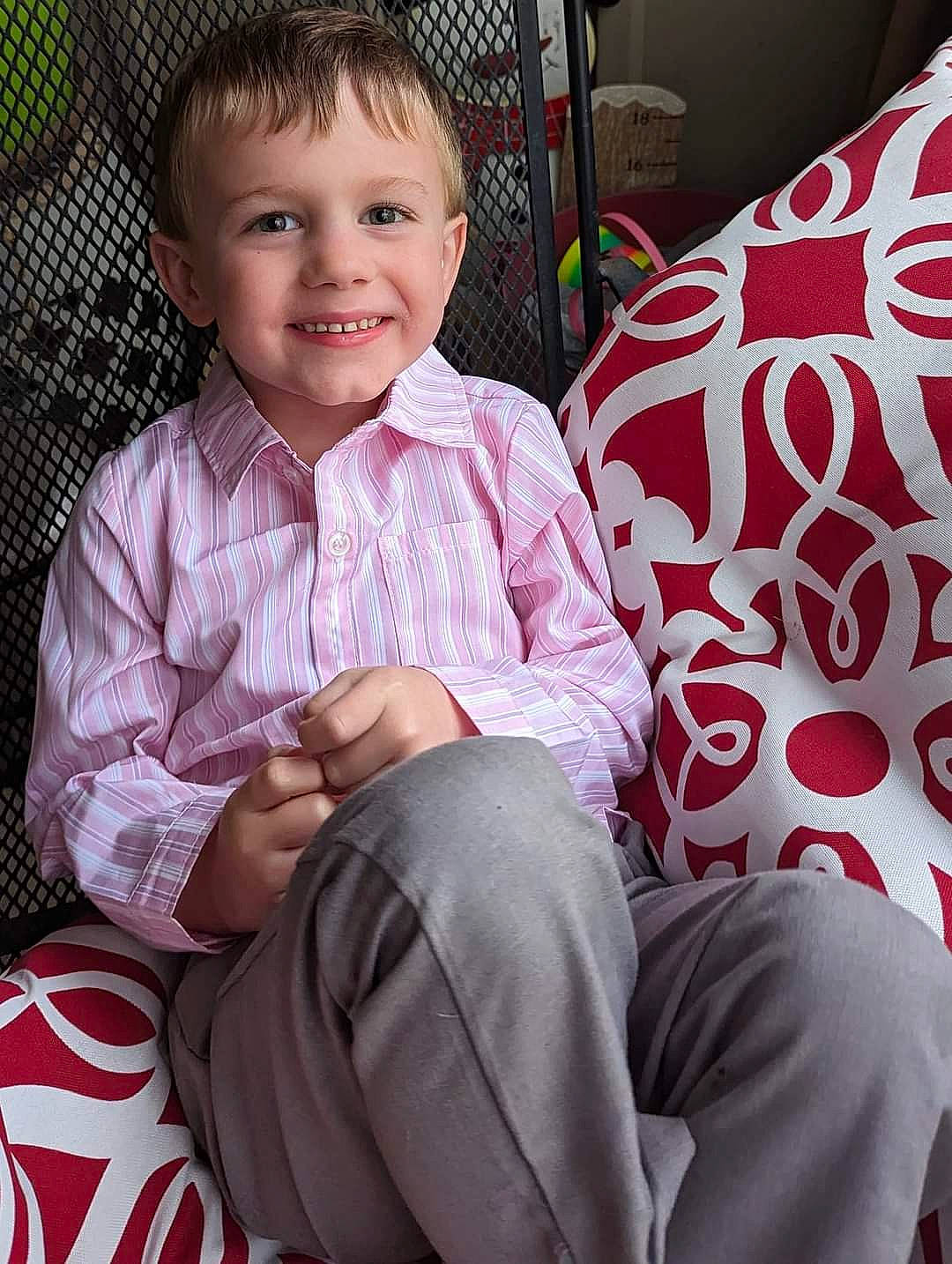 Kayden is registered to the contest to win money with this photo: baby, baby_toddler_clothing, cheek, chin, comfort, couch, event, eye, fun, happy, joy, lap, leg, magenta, people, person, pink, sitting, skin, sleeve