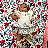 Nirahylez is registered to the contest to win money with this photo: apparel, baby, blanket, child, colorful, cute, dress, fabric, floral, flower_pattern, headband, indoor, infant, lying_down, mittens, pattern, person, portrait, shoes, soft_texture