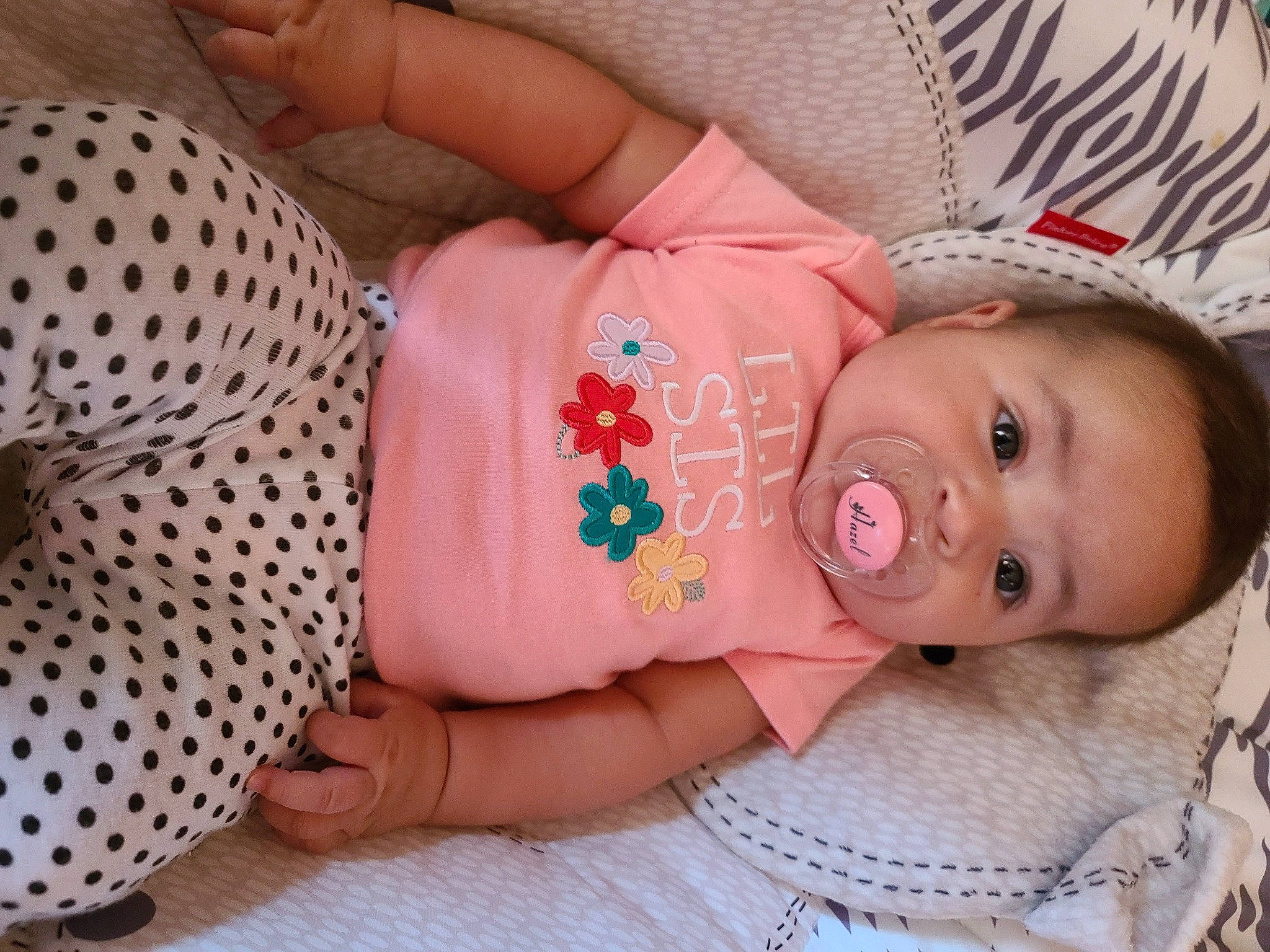 Hazel is registered to the contest to win money with this photo: baby, baby_toddler_clothing, beauty, cheek, dress, eyelash, finger, hat, headgear, human_body, iris, lip, nose, pattern, person, pink, product, skin, sleeve, textile