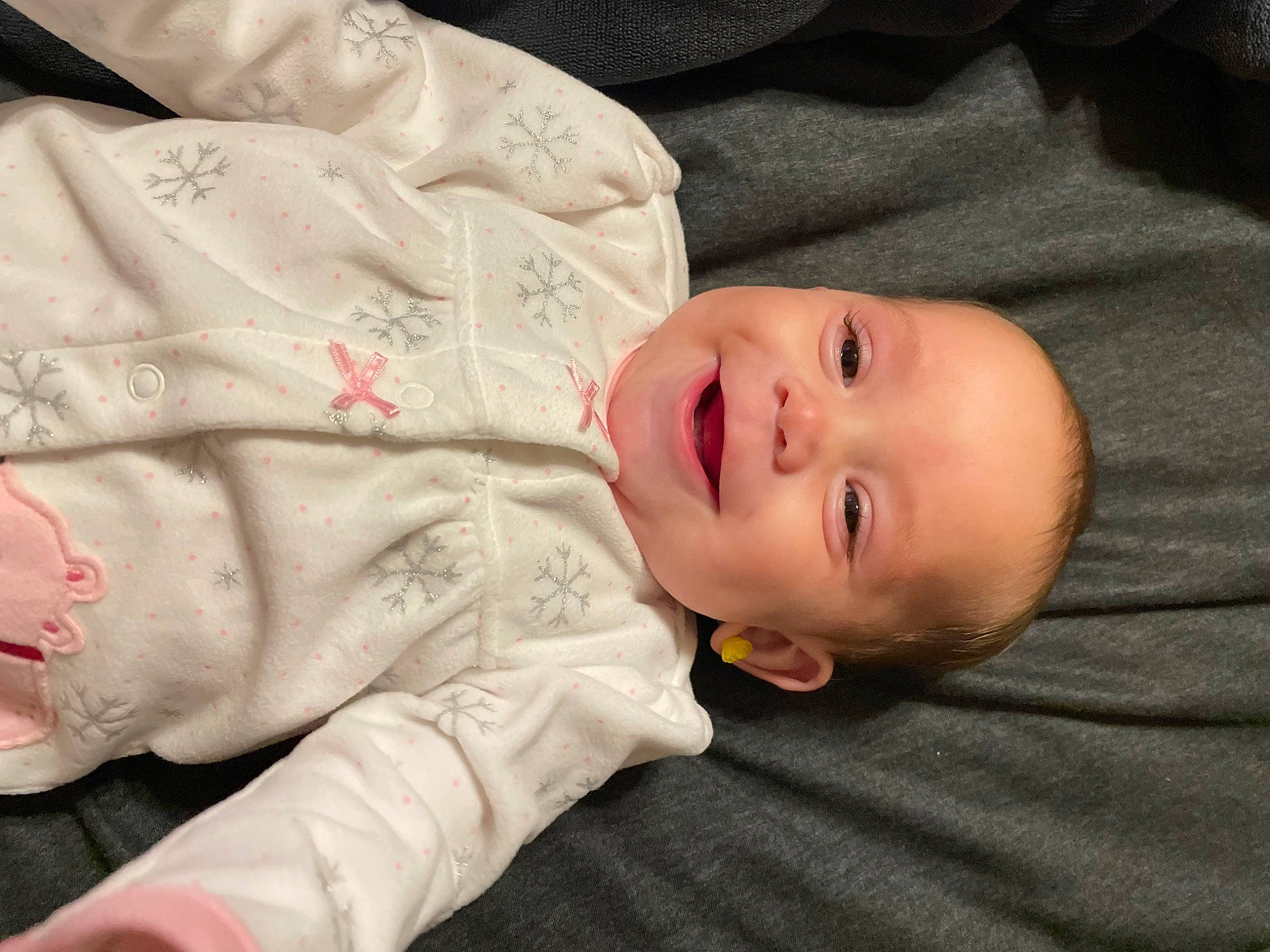 Eliza is registered to the contest to win money with this photo: baby, baby_toddler_clothing, cheek, child, chin, comfort, eye, flash_photography, flooring, grass, happy, joy, mammal, nose, person, portrait_photography, sitting, skin, sleeve, smile