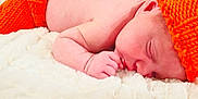 Greyson is registered to the contest to win money with this photo: baby, blanket, closeup, cozy, cute, face, hand, infant, knitted_clothing, lying_down, newborn, orange_hat, orange_pants, peaceful, portrait, resting, skin, sleeping, soft_texture, warm