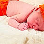 Greyson is registered to the contest to win money with this photo: baby, newborn, sleeping, orange_hat, orange_pants, blanket, soft_texture, infant, cute, resting, skin, knitted_clothing, peaceful, closeup, face, hand, lying_down, cozy, warm, portrait