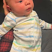 Greyson joined the competition — help win amazing prizes! baby, newborn, infant, onesie, striped_clothing, person, child, sleepwear, cute, small, soft_lighting, hand, cradled, portrait, indoor, skin, face, expression, curious, lying_down