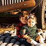 Tessa is registered to the contest to win money with this photo: child, children, toddler, baby, blanket, vintage_car, rustic, outdoor, sunlight, fall, grass, bow, clothing, cute, portrait, smile, sitting, brother, sister, family