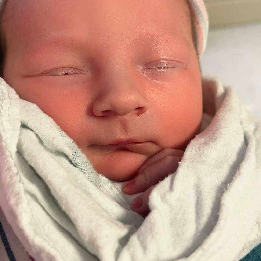 Michael joined the competition — help win amazing prizes! baby, blanket, bonnet, cap, clothing, face, hat, head, hood, newborn, person, photography, portrait, quilt, sleeping, towel