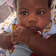 Delijah joined the competition — help win amazing prizes! baby, infant, child, face, hands, onesie, blue_clothing, curly_hair, lying_down, blanket, patterned_blanket, indoor, closeup, cute, chubby_cheeks, spiderman, resting, skin, portrait, adorable