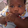 baby, infant, child, face, hands, onesie, blue_clothing, curly_hair, lying_down, blanket, patterned_blanket, indoor, closeup, cute, chubby_cheeks, spiderman, resting, skin, portrait, adorable