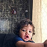 Zymere Lasanta joined the competition — help win amazing prizes! casual, child, curly_hair, curtain, cushion, expression, face, framed_photo, home, indoor, looking_away, natural_light, person, portrait, sofa, tile, toddler, wall, window_light, young_child