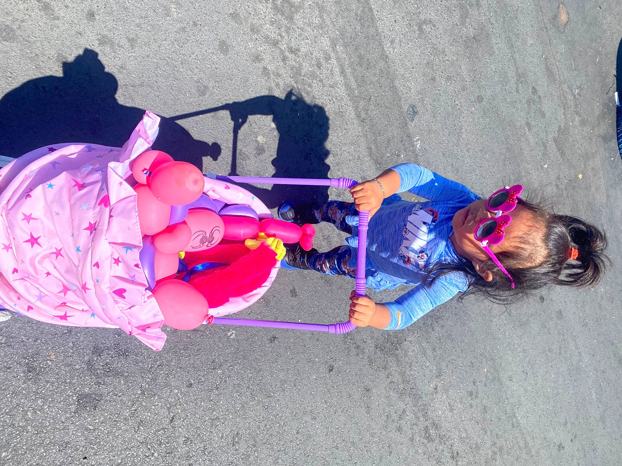 Genesis is registered to the contest to win money with this photo: baby, baby_products, baby_toddler_clothing, carmine, child, costume, electric_blue, fun, hat, leisure, magenta, person, personal_protective_equipment, pink, play, purple, recreation, sidewalk, sitting, toddler