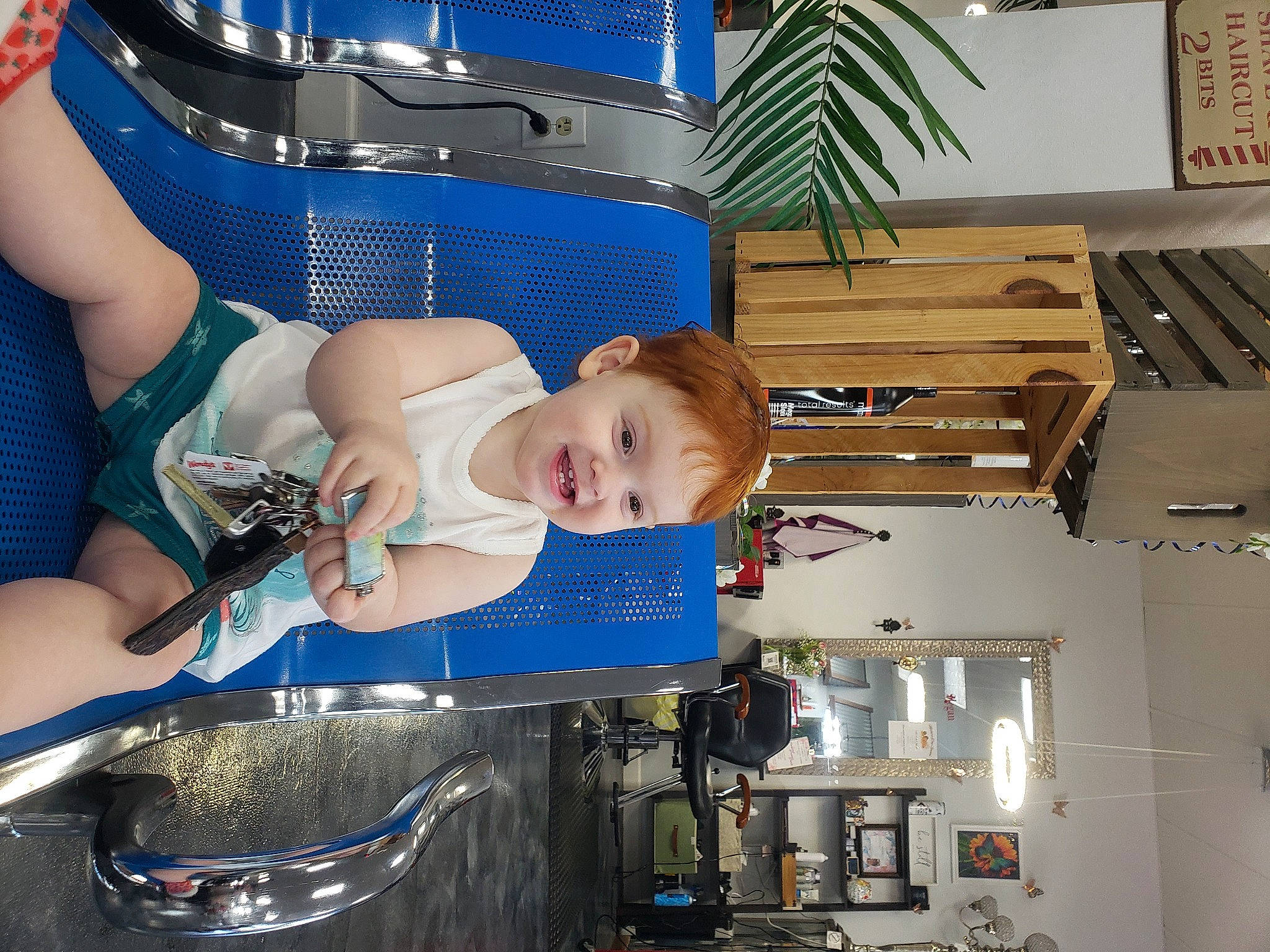 Brittney is registered to the contest to win money with this photo: baby, baby_carriage, baby_products, blue, chair, child, electric_blue, fun, home_appliance, houseplant, joy, kitchen, machine, person, personal_protective_equipment, plant, room, sitting, smile, t_shirt