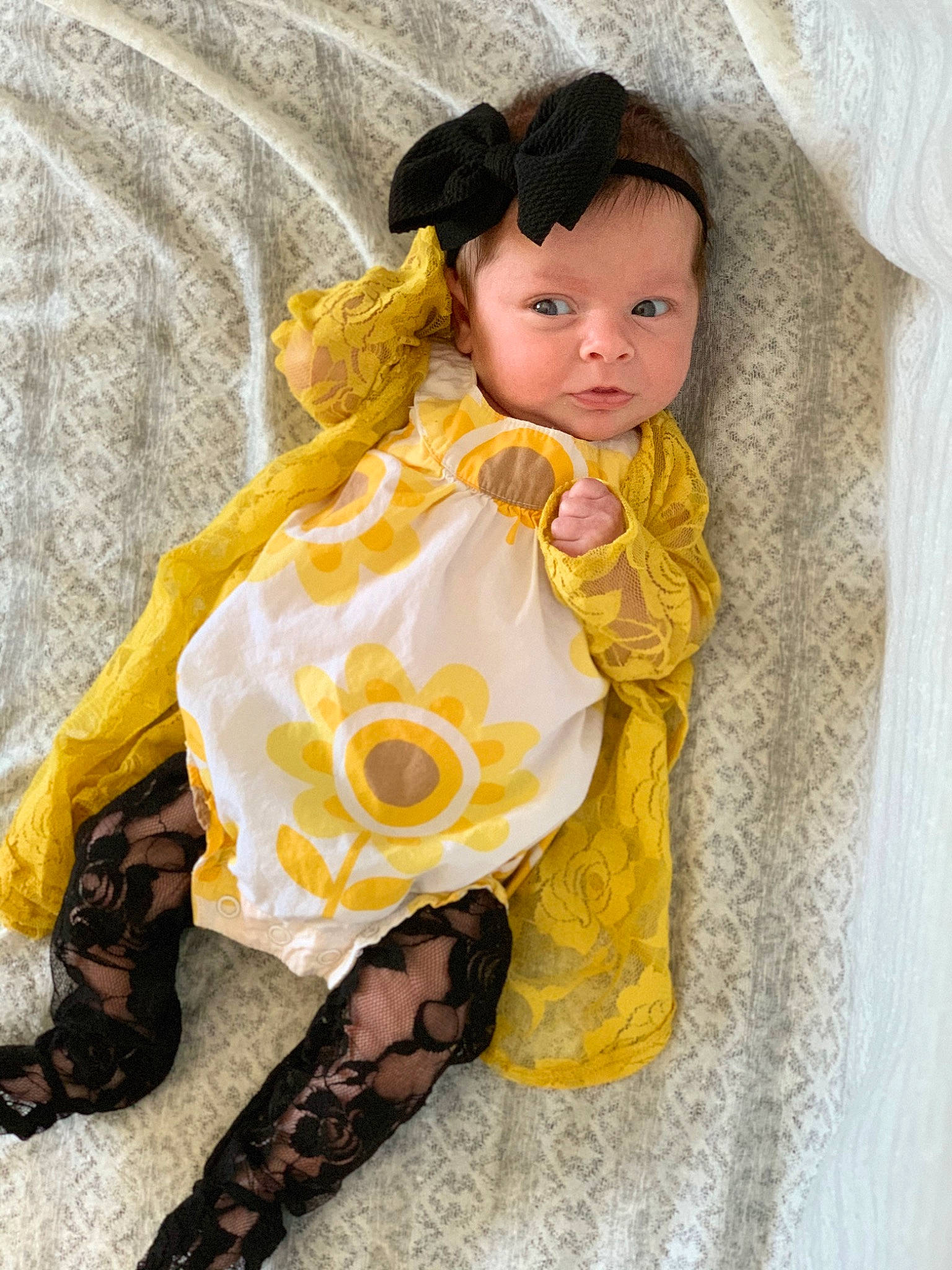 Lilian is registered to the contest to win money with this photo: baby, brown_hair, child, costume, doll, long_hair, outerwear, person, textile, toddler, toy, yellow