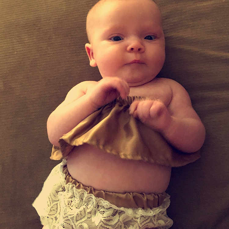 Annabelle is registered to the contest to win money with this photo: abdomen, arm, baby, cheek, child, eye, finger, hand, head, leg, lip, mouth, muscle, person, sitting, skin, smile, stomach, thumb, toddler
