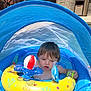 toddler, child, inflatable_pool, yellow_float, blue_canopy, water, toy, outdoor, summer, sunlight, curious, baby, swimming, play, pool_toy, inflatable_toy, shade, young_child, summer_fun, recreation
