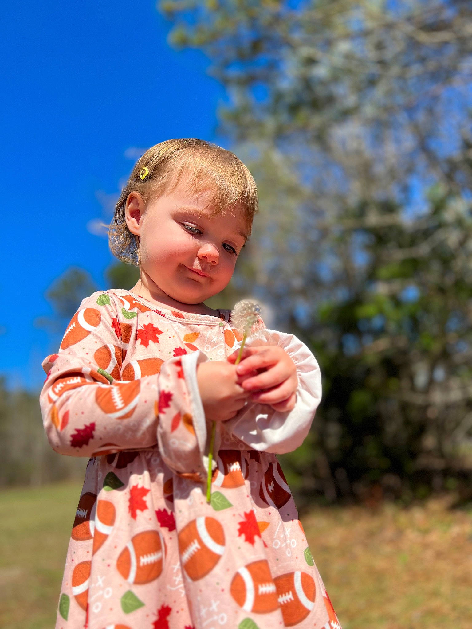 Delaney joined the competition — help win amazing prizes! baby, baby_toddler_clothing, blond, child, day_dress, dress, fun, grass, hand, happy, pattern, peach, people_in_nature, person, plant, play, portrait_photography, sky, sleeve, toddler