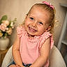 Lindsay Sabrina a rejoint le concours — aidez-le/la à gagner de superbes lots ! child, smiling, girl, pink, bow, ruffled_top, blue_jeans, chair, flower_vase, indoor, portrait, happy, cute, toddler, blonde_hair, casual, seated, home, decor, closeup