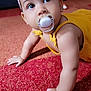 Léa participe au concours pour gagner de l'argent avec cette photo : baby, pacifier, headband, flower, yellow_outfit, crawling, carpet, indoor, child, cute, portrait, skin, hand, face, eyes, earrings, infant, young_child, closeup, curious