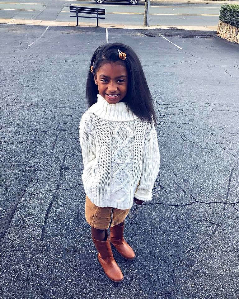 Emani is registered to the contest to win money with this photo: beauty, child, cool, dress, fashion, footwear, head, joy, outerwear, people, person, photography, shoe, skin, sky, smile, snapshot, standing, street_fashion, summer