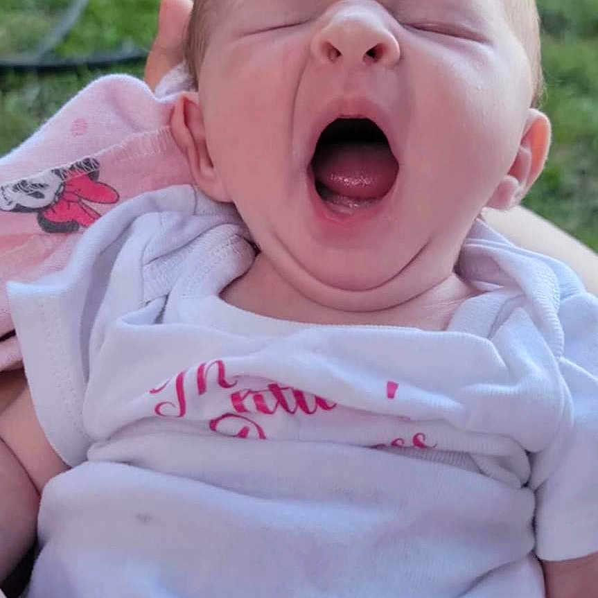 Addison is registered to the contest to win money with this photo: baby, clothing, crying, face, grass, happy, head, laughing, nature, newborn, outdoors, park, person, photography, plant, portrait, quilt, sad, t_shirt, yawning