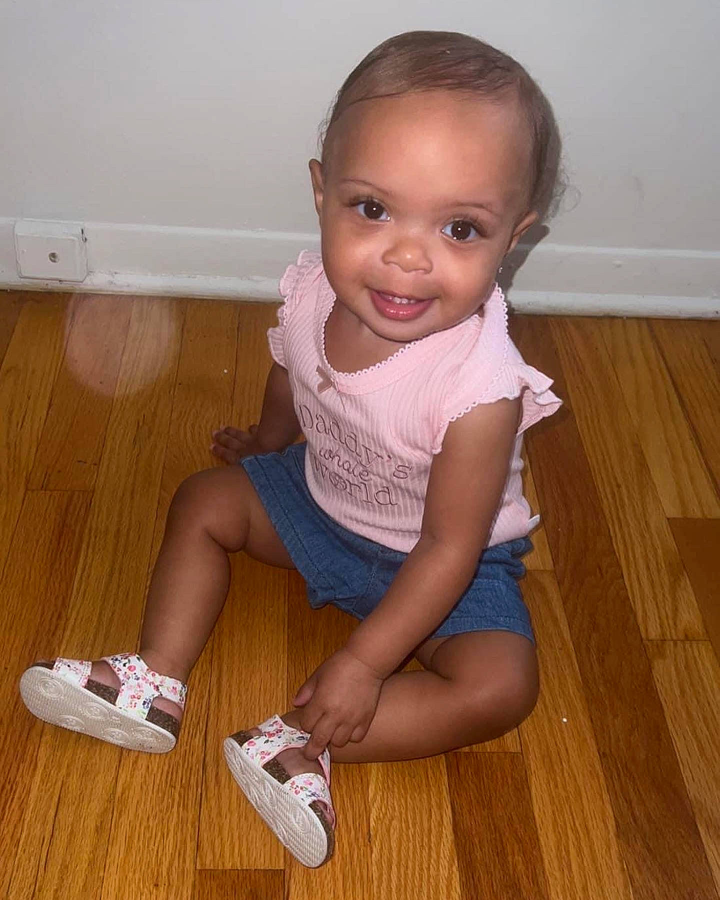 Kalani joined the competition — help win amazing prizes! baby_toddler_clothing, cheek, finger, floor, flooring, foot, hardwood, human_leg, joint, joy, knee, laminate_flooring, person, sleeve, sock, standing, thigh, toddler, trunk, varnish