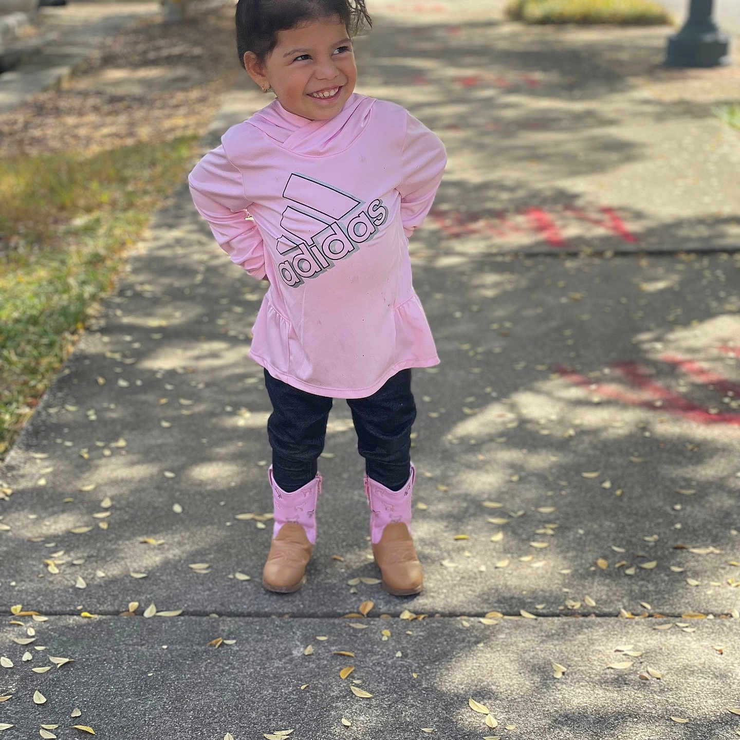 Valeria is registered to the contest to win money with this photo: child, city, clothing, face, female, girl, grass, head, nature, outdoors, pants, park, path, person, photography, portrait, road, standing, street, urban