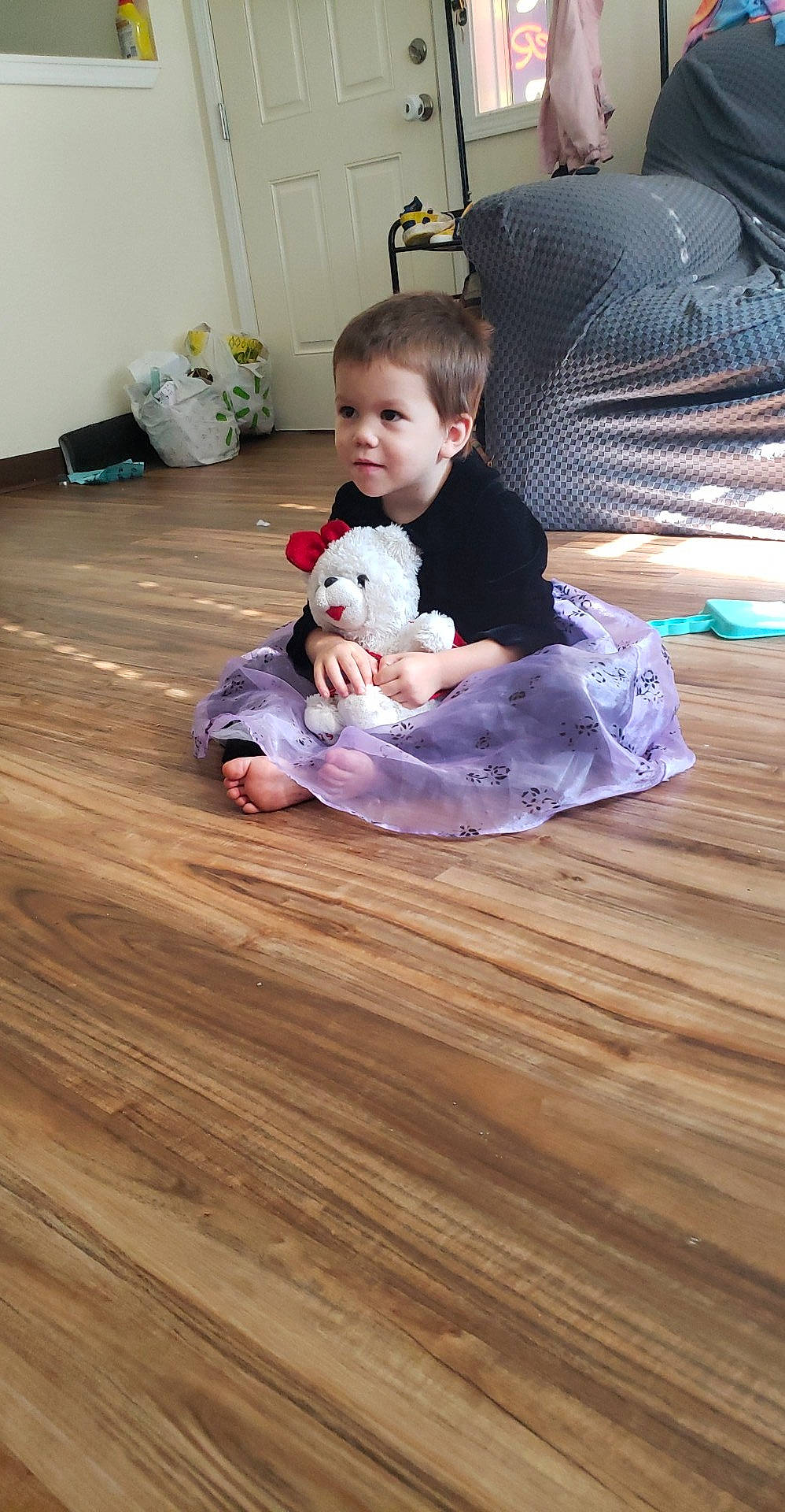 Trinidy joined the competition — help win amazing prizes! baby, barefoot, child, comfort, companion_dog, floor, flooring, foot, happy, hardwood, human_leg, knee, laminate_flooring, lap, person, room, sitting, toddler, toy, wood