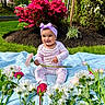 baby, blanket, child, colorful, flower, flowers, garden, grass, greenery, happy, headband, nature, outdoor, pajamas, pink_flower, plants, portrait, sitting, smiling, spring
