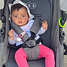 baby, stroller, child, hat, pink_pants, footwear, toy, pacifier, can, seatbelt, outdoor, expression, face, hands, feet, clothing, plaything, infant, safety_harness, sun_hat