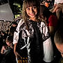 Rose Tuccino joined the competition — help win amazing prizes! child, smiling, girl, crowd, arena, spectators, indoor, event, seated, people, casual_clothing, graphic_shirt, long_hair, fringe, happy, portrait, person, dark_background, lighting, audience