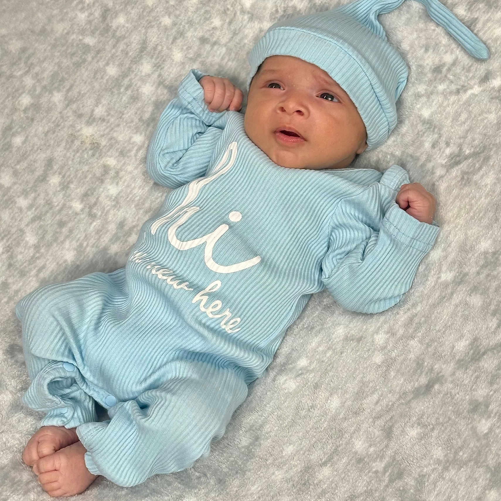 Max joined the competition — help win amazing prizes! baby, blue_clothing, child, cozy, cute, expression, fist, hat, headwear, indoor, infant, lying_down, newborn, onesie, portrait, ribbed_fabric, skin, sleepwear, soft_blanket, tiny_feet