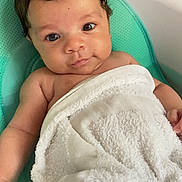 Travis is registered to the contest to win money with this photo: baby, infant, towel, seat, cute, child, skin, face, eyes, hair, arm, hand, expression, indoor, comfort, soft, relaxation, person, portrait, newborn