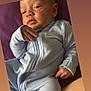 Giovanni joined the competition — help win amazing prizes! baby, infant, onesie, blue_clothing, face, hand, skin, person, newborn, portrait, cute, child, comfortable, soft, resting, indoors, closeup, expression, human, sitting