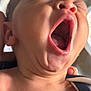 Giovanni is registered to the contest to win money with this photo: baby, infant, yawning, face, mouth_open, skin, close_up, head, neck, ear, tongue, sleepy, human, newborn, child, expression, hand, clothing, blurred_background, soft_light