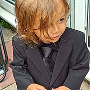 Rowan joined the competition — help win amazing prizes! child, boy, suit, tie, blond_hair, outdoor, curly_hair, portrait, fashion, formal_wear, person, cute, standing, window, door, hand, expression, young, clothing, casual_background