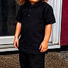 attitude, black_clothing, casual, child, concrete, cool, curly_hair, door, fashion, full_body, hair, outdoor, person, portrait, serious, shoes, standing, sunglasses, toddler, young_child