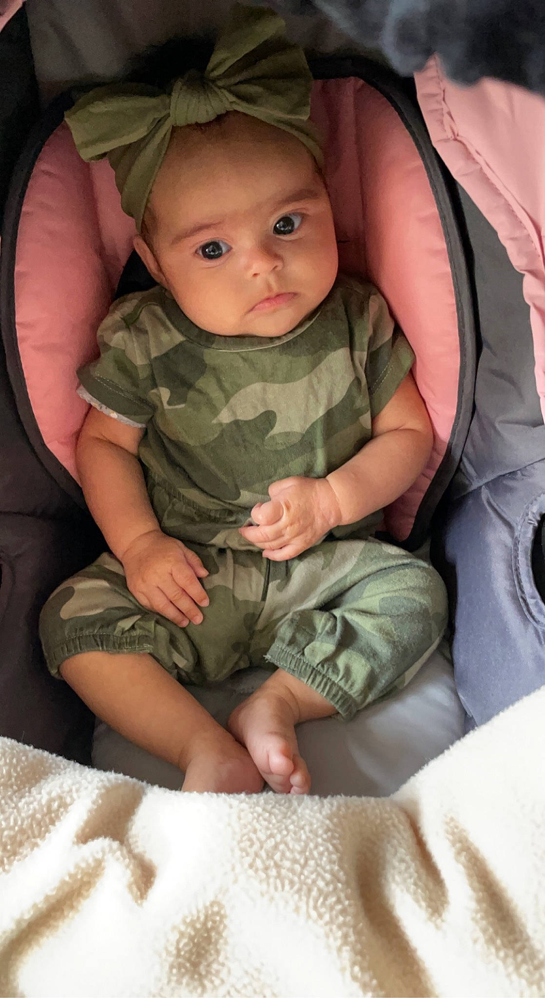 Kamilah is registered to the contest to win money with this photo: arm, baby, baby_toddler_clothing, beauty, cheek, child, comfort, finger, gesture, human_body, lap, leg, mouth, pattern, person, sitting, skin, sleeve, thigh, thumb