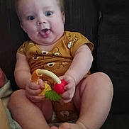 Cylas Walker is registered to the contest to win money with this photo: baby, infant, child, toy, onesie, couch, smiling, happy, cute, playful, sitting, feet, hands, face, indoors, person, young, clothing, expression, holding
