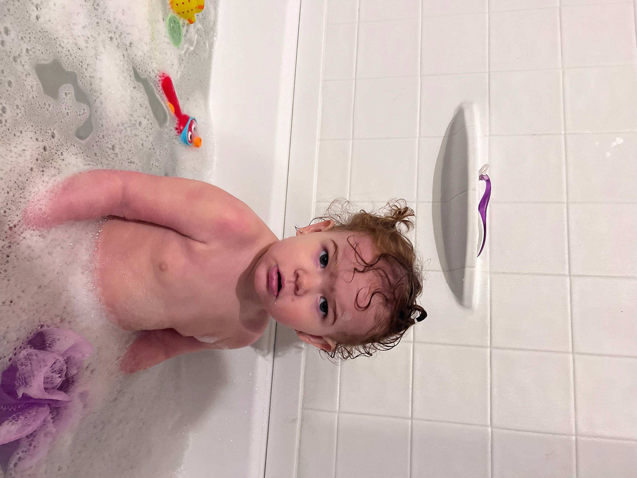 Karoline is registered to the contest to win money with this photo: arm, bathing, bathroom, chest, child, elbow, eyelash, fun, happy, human_body, human_leg, leg, leisure, nail, party_supply, person, pink, room, skin, textile