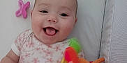 Meryl participe au concours pour gagner de l'argent avec cette photo : baby, bed, child, colorful, crib, cute, face, happy, indoor, infant, mouth_open, onesie, pacifier, person, plush_toy, sleeping_area, smiling, soft, tongue_out, toy