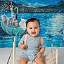 baby, child, smiling, blue_outfit, suspenders, small_bed, fluffy_cushion, white_floor, colorful_backdrop, umbrella_boat, giraffe, elephant, polar_bear, starry_sky, musical_notes, water, mountains, indoor, portrait, happy