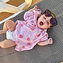 baby, child, infant, towel, sunglasses, pink, strawberry_pattern, diaper, sun_lounger, outdoor, happy, yawning, relaxing, cute, smiling, skin, person, summer, leisure, daylight
